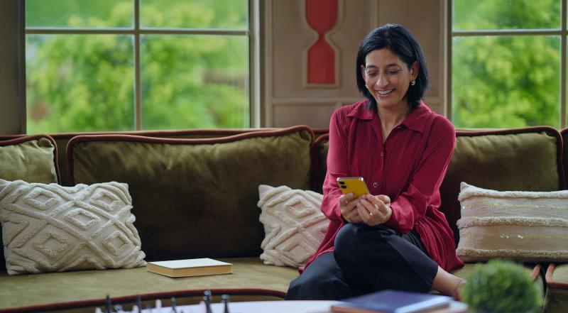 Woman typing on phone.